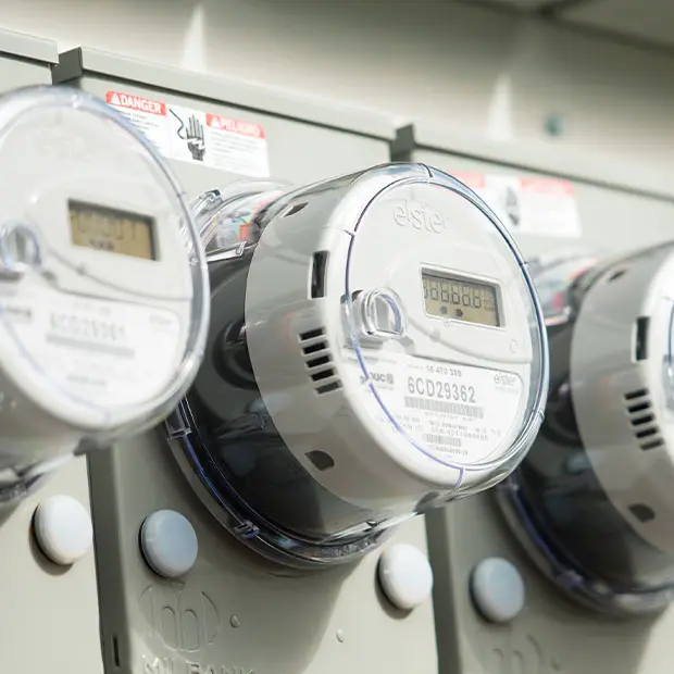Electric meter farm with a closeup of two meters.