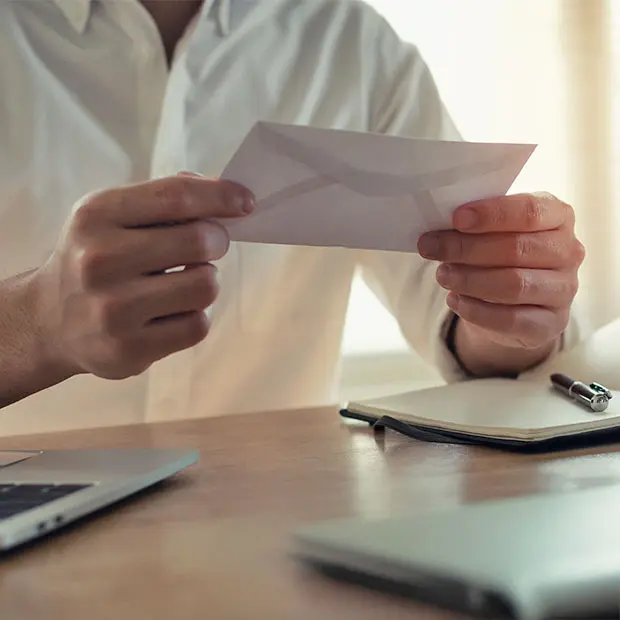 A man holding an envelope.