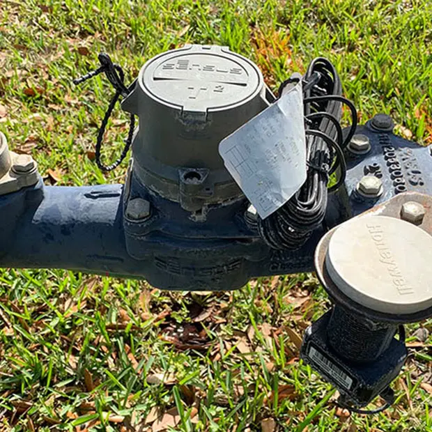 An AMI water meter on a lawn.