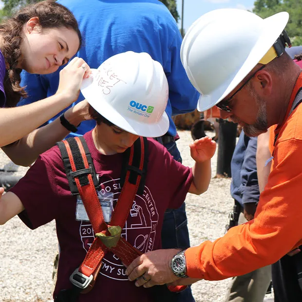OUC employees teaching children about work in the utilities industry