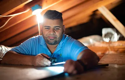 Conservation Audits: image shows a conservation specialist inspecting a roof