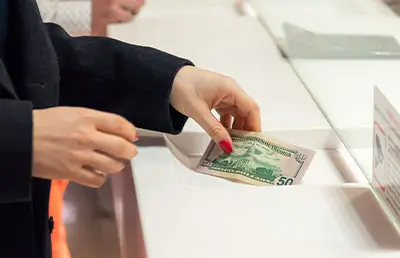 A woman making a bill payment in person.