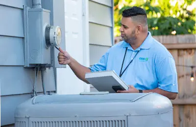 OUC conservation specialist examining a customer's electric meter.