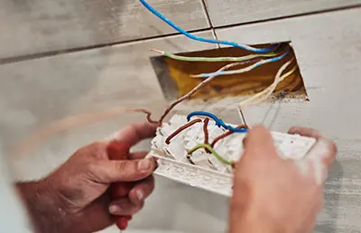 An electrician examining a home's electric lines.