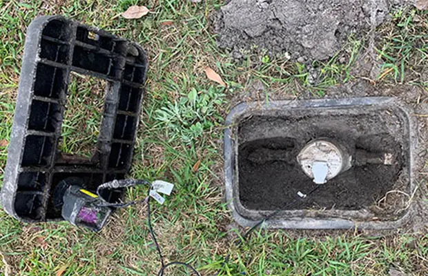 An open water meter box, showcasing how these could be a safety hazard.